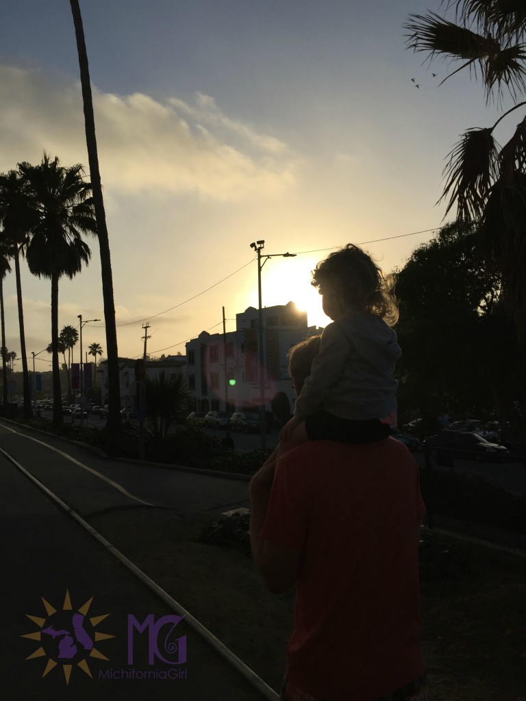 toddler on daddy's shoulders in sunset