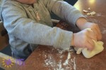 child hands playing with dough