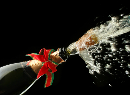 celebration champagne splash, bottle and cork opening, with Christmas decoration