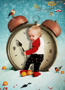 baby standing in front of large alarm clock