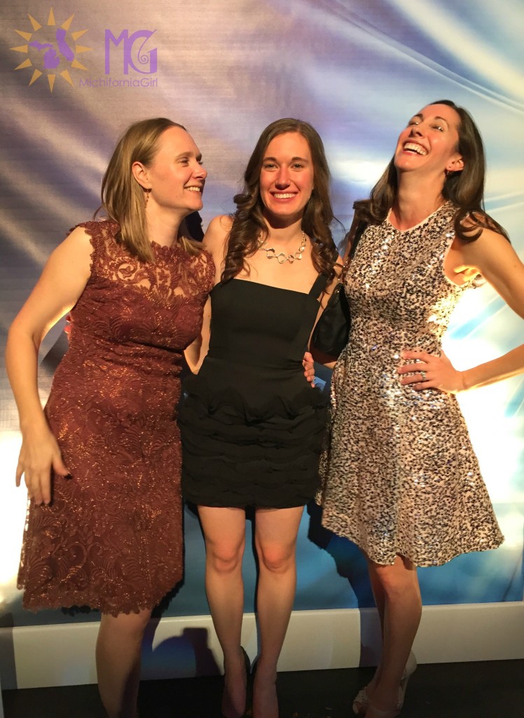three women in dresses at a party