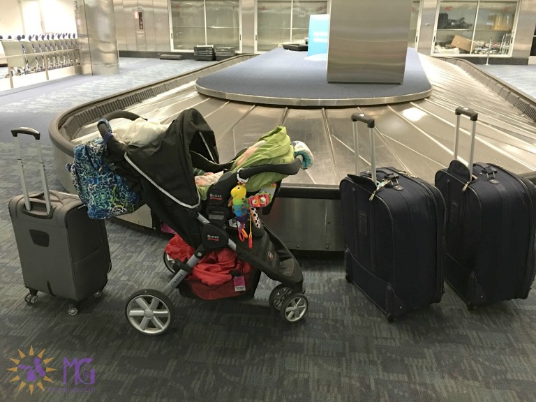 empty baggage claim at airport with suitcases and stroller