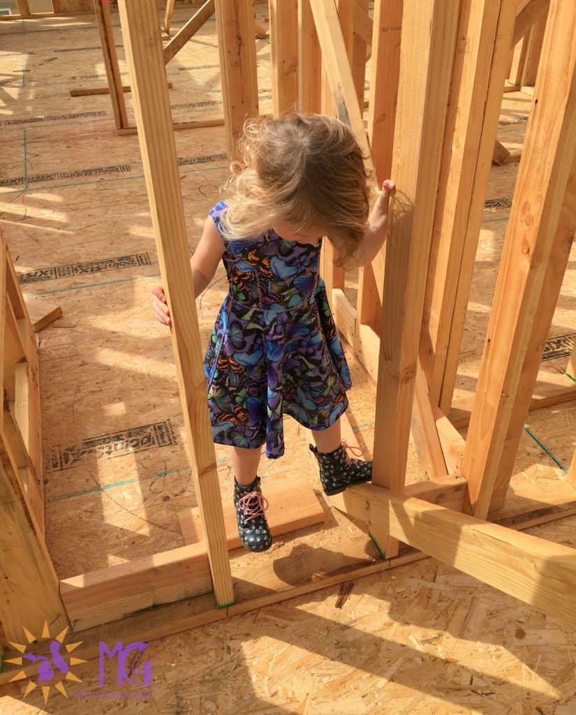 girl climbing on new construction board frame